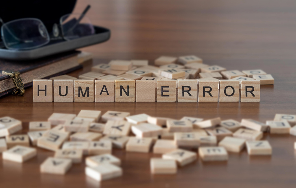 a set of small wooden tiles with letters that spell out the words Human error